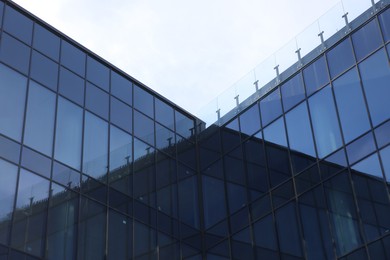 Photo of Exterior of modern building with many windows outdoors, low angle view