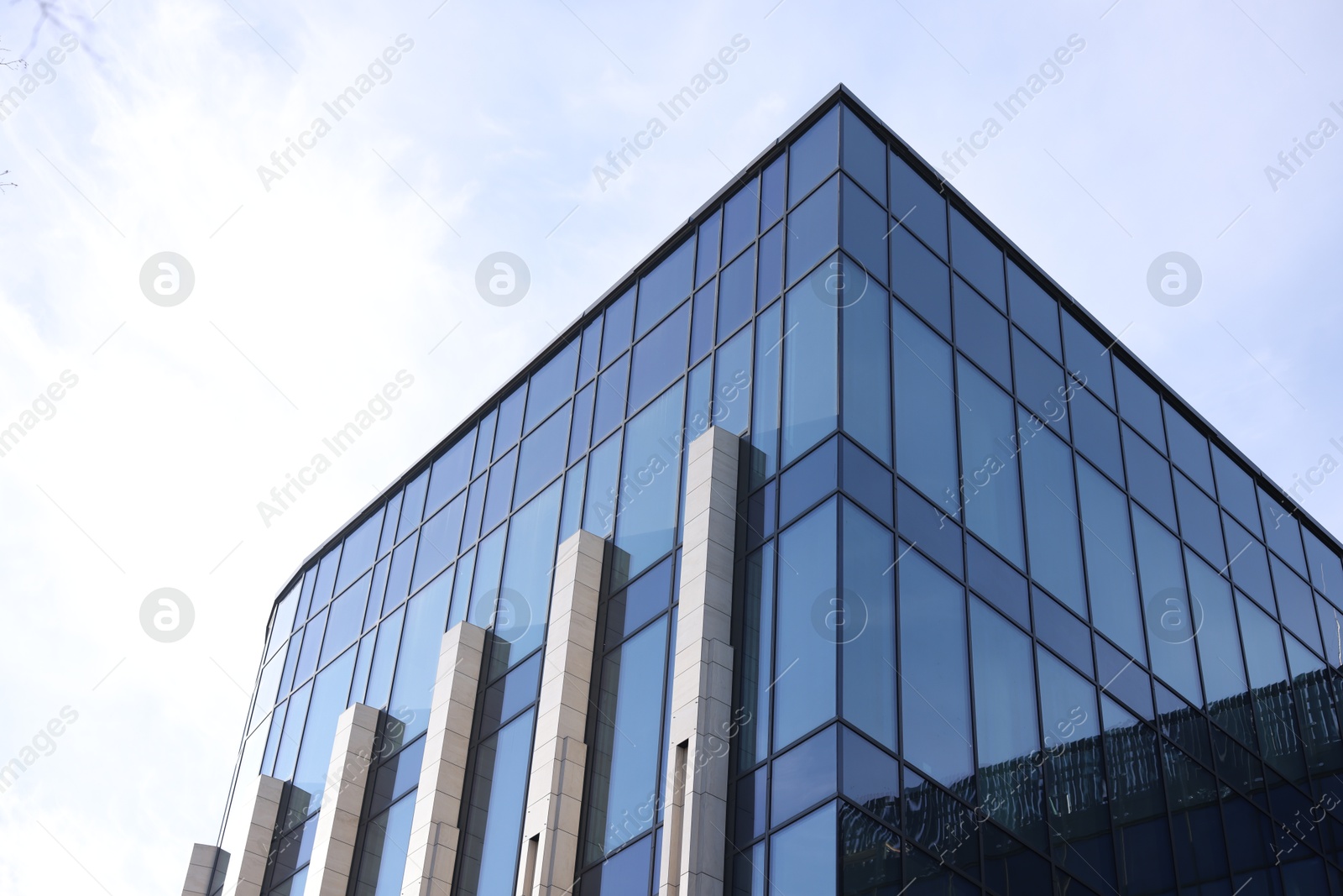 Photo of Exterior of modern building with many windows outdoors, low angle view