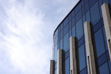 Photo of Exterior of modern building with many windows outdoors, low angle view. Space for text