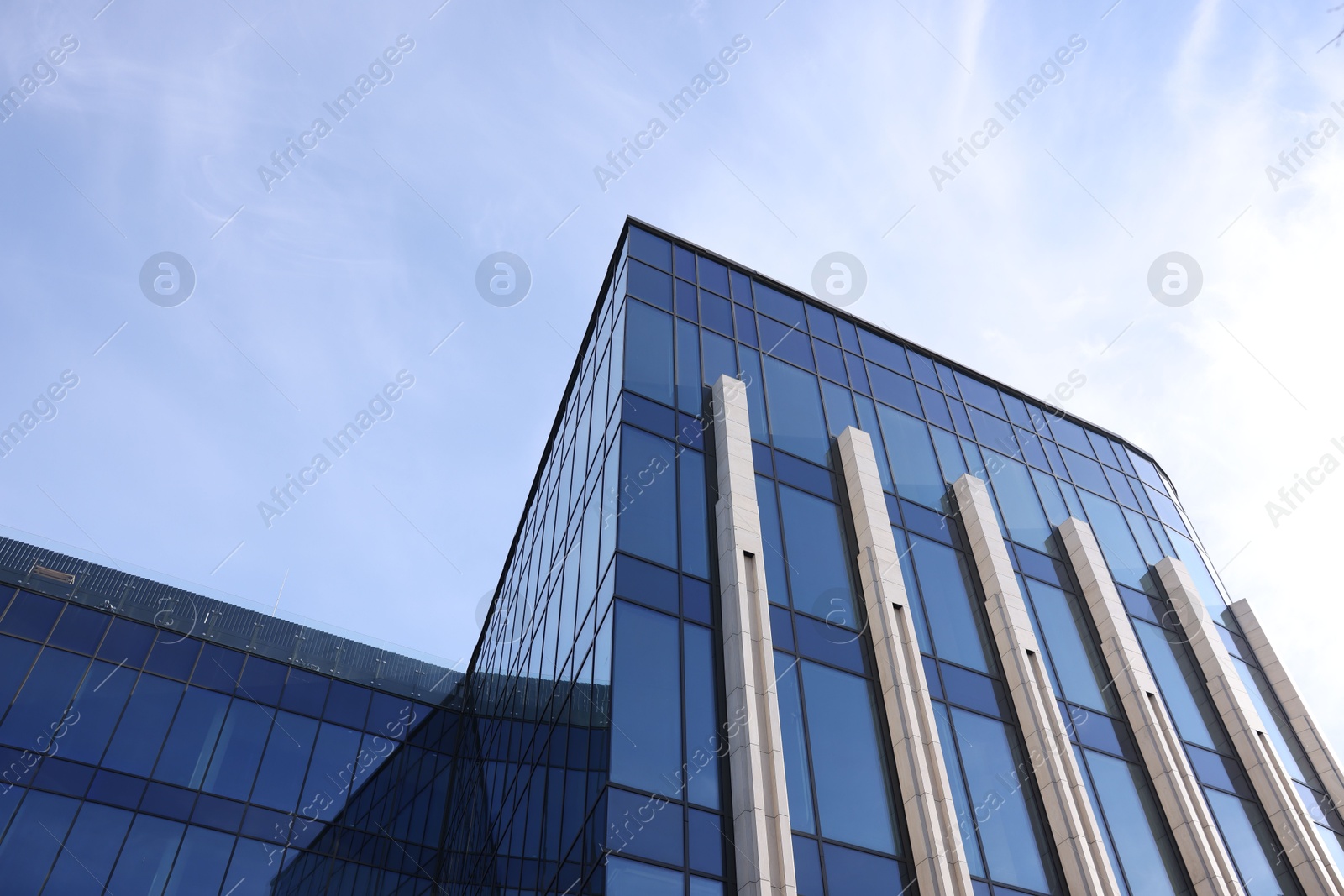 Photo of Exterior of modern building with many windows outdoors, low angle view