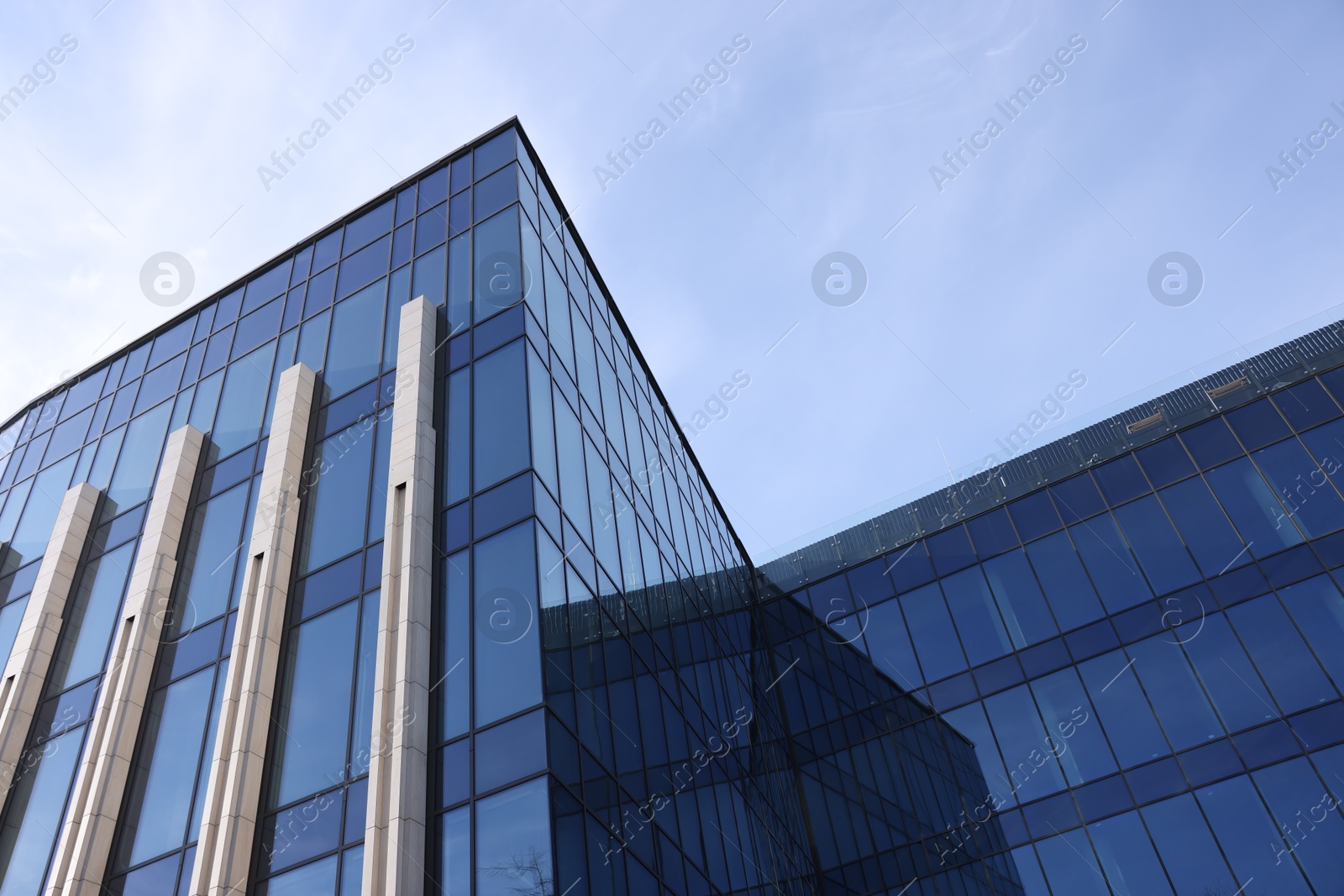 Photo of Exterior of modern building with many windows outdoors, low angle view