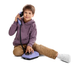 Photo of Cute little boy with old telephone on white background