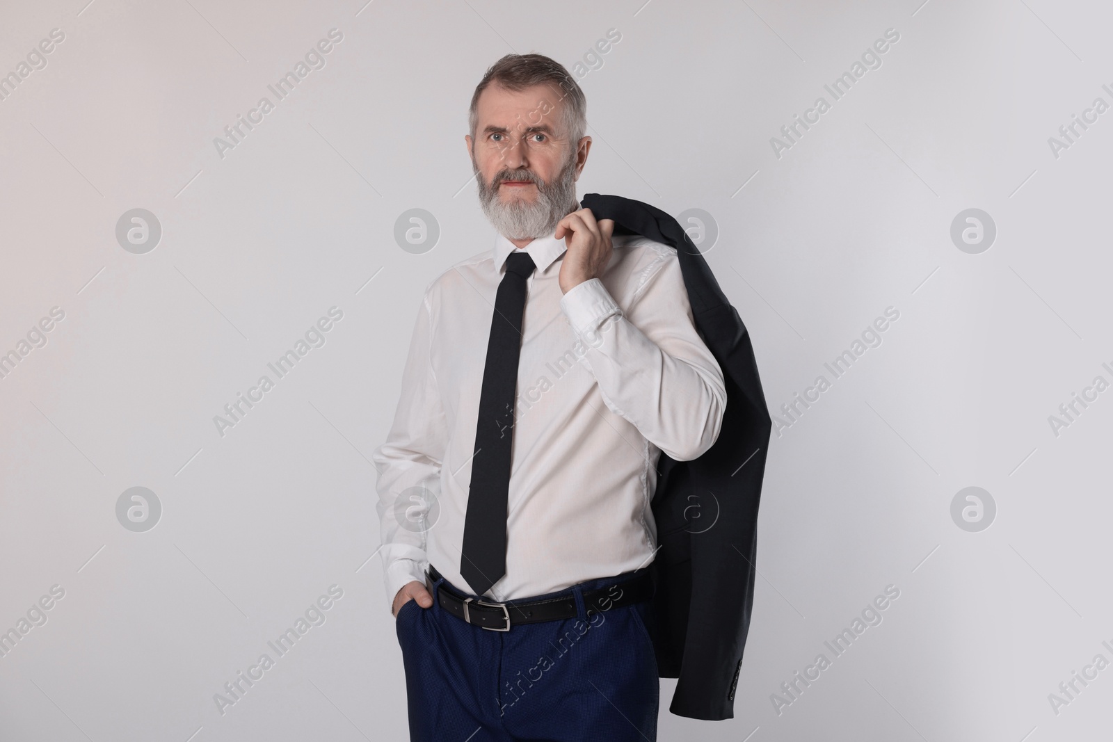 Photo of Portrait of senior man in suit on white background