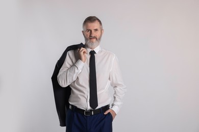 Photo of Portrait of senior man in suit on white background