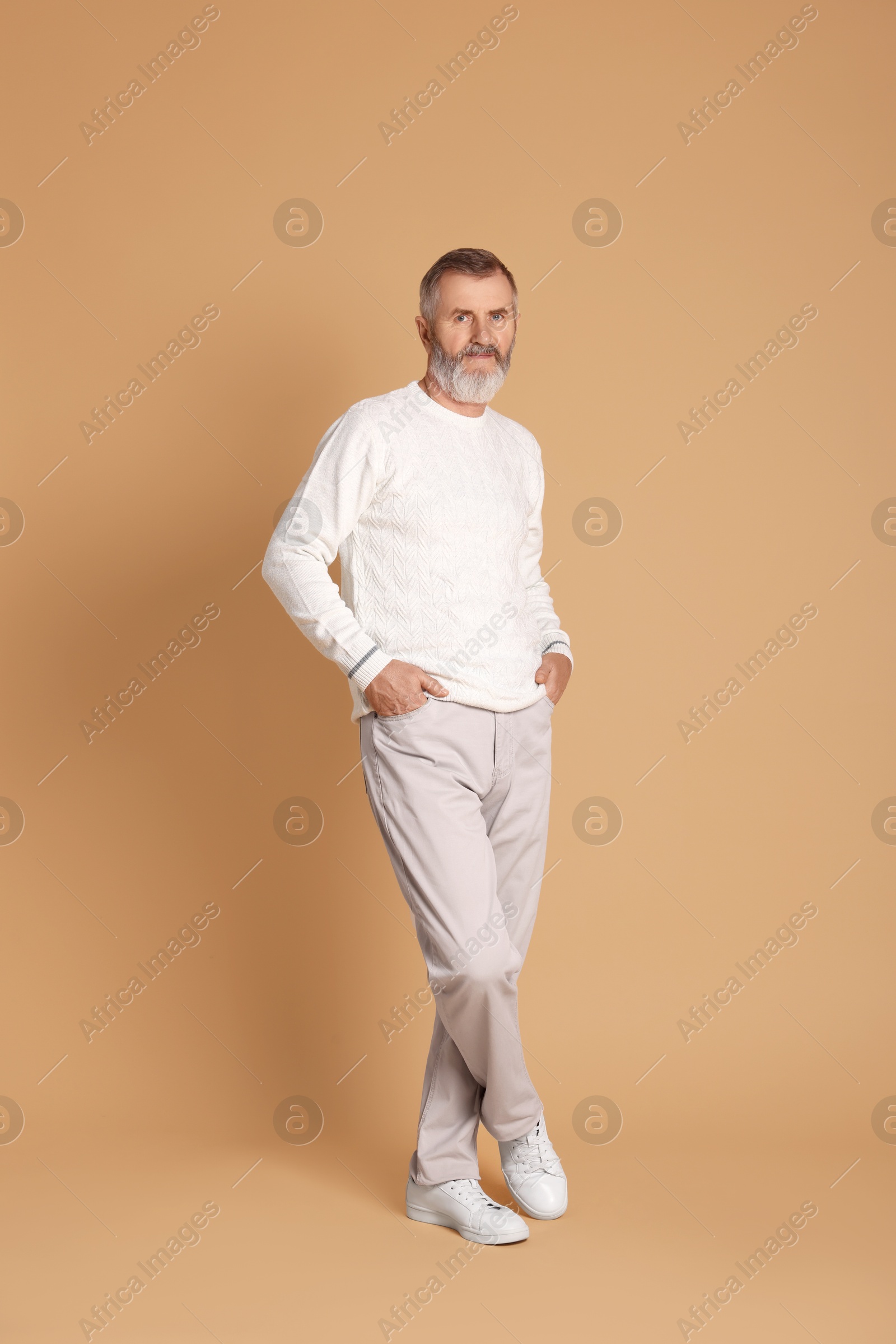 Photo of Portrait of senior man on beige background