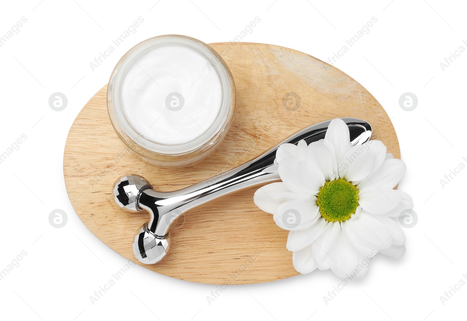 Photo of Face roller, cream and flower isolated on white, top view