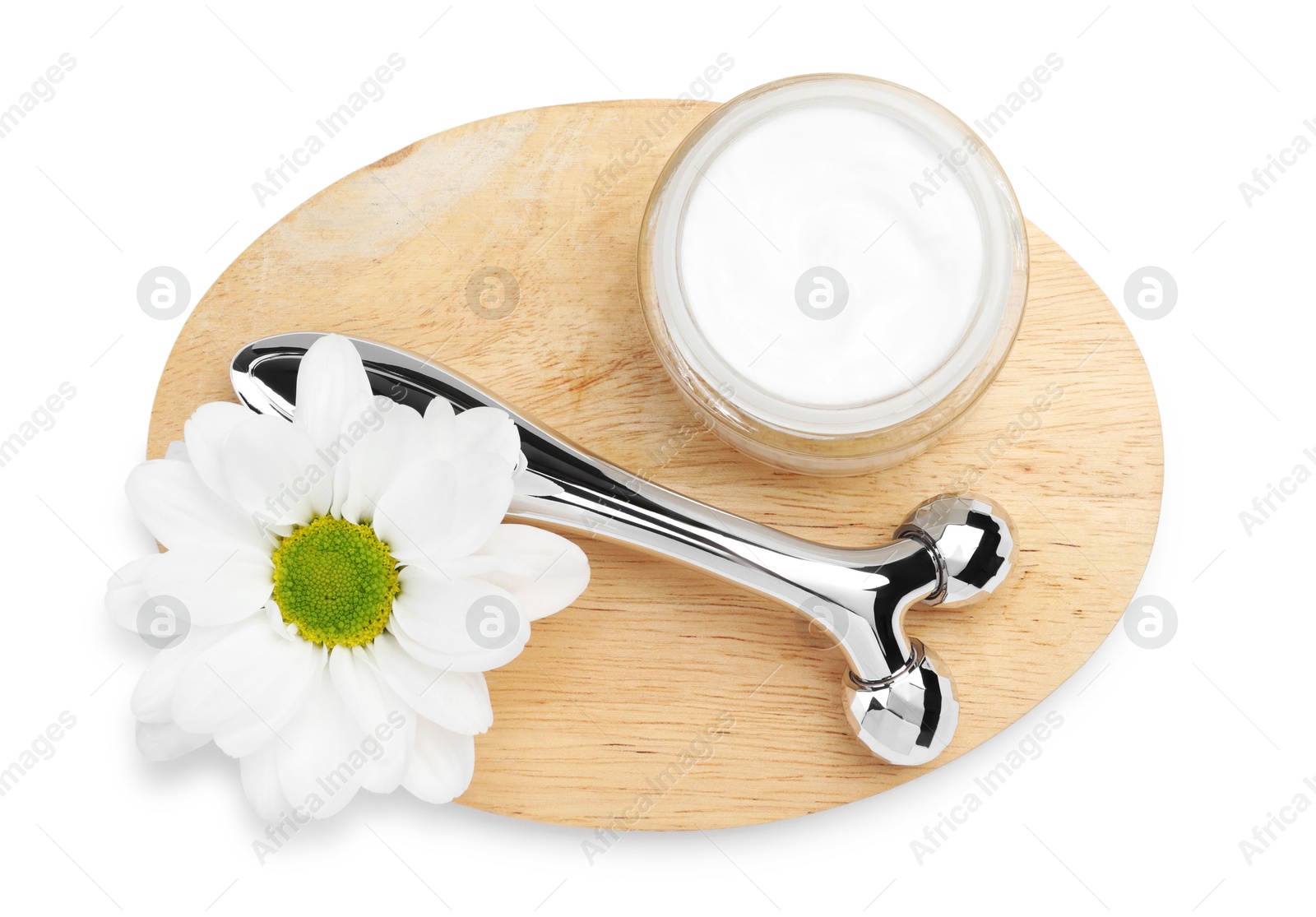 Photo of Face roller, cream and flower isolated on white, top view