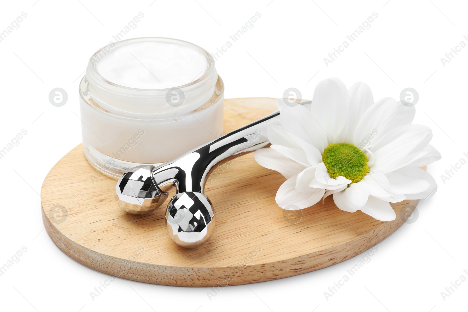 Photo of Face roller, cream and flower isolated on white