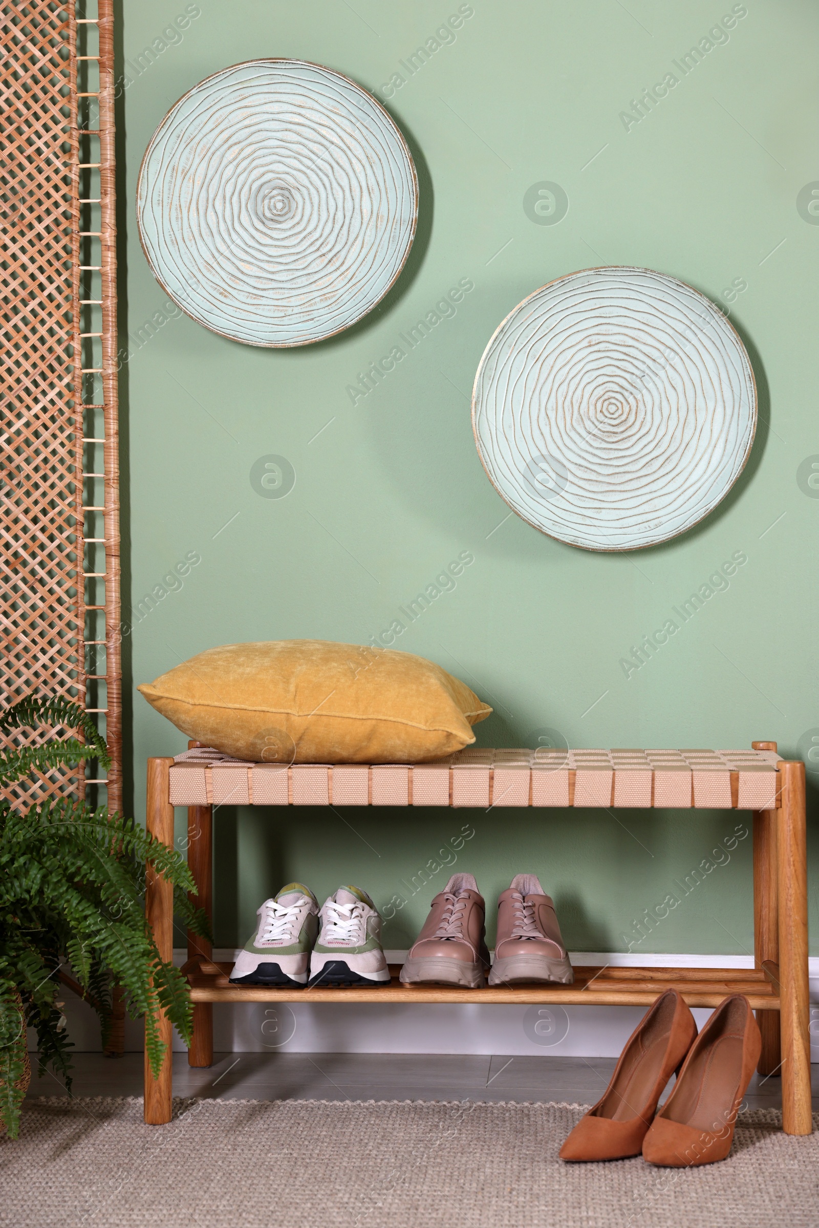 Photo of Stylish hallway interior with bench and folding screen