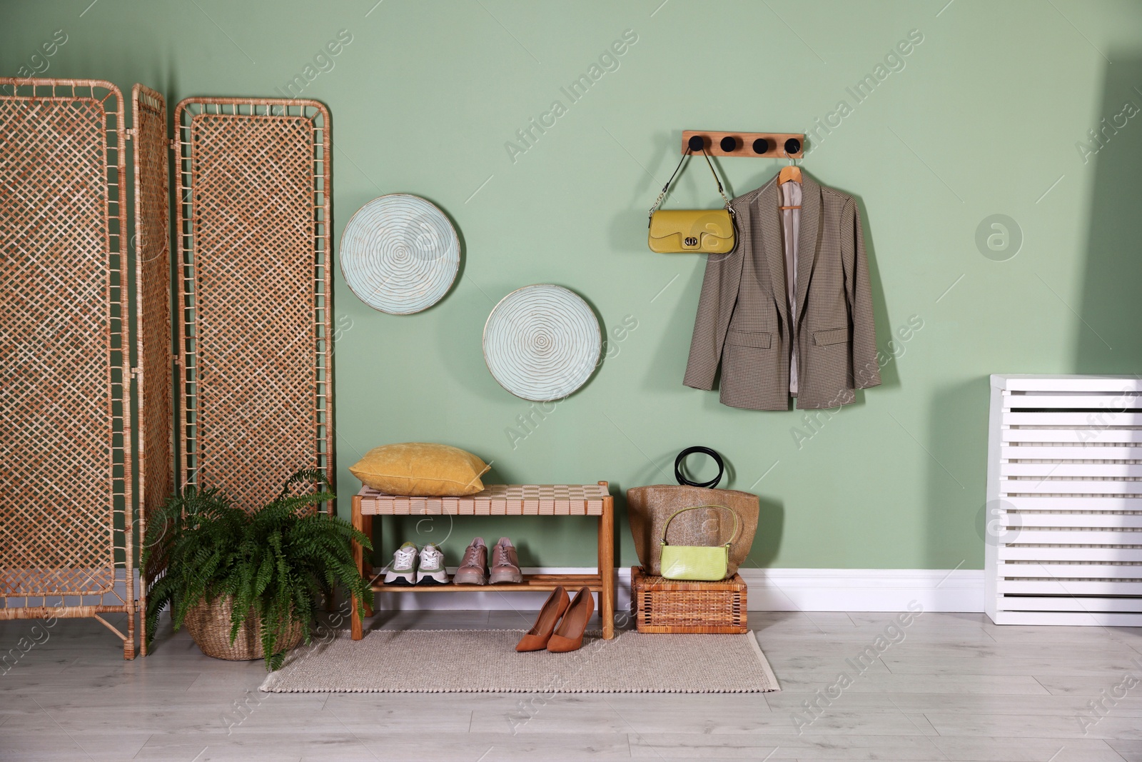 Photo of Stylish hallway interior with bench and folding screen