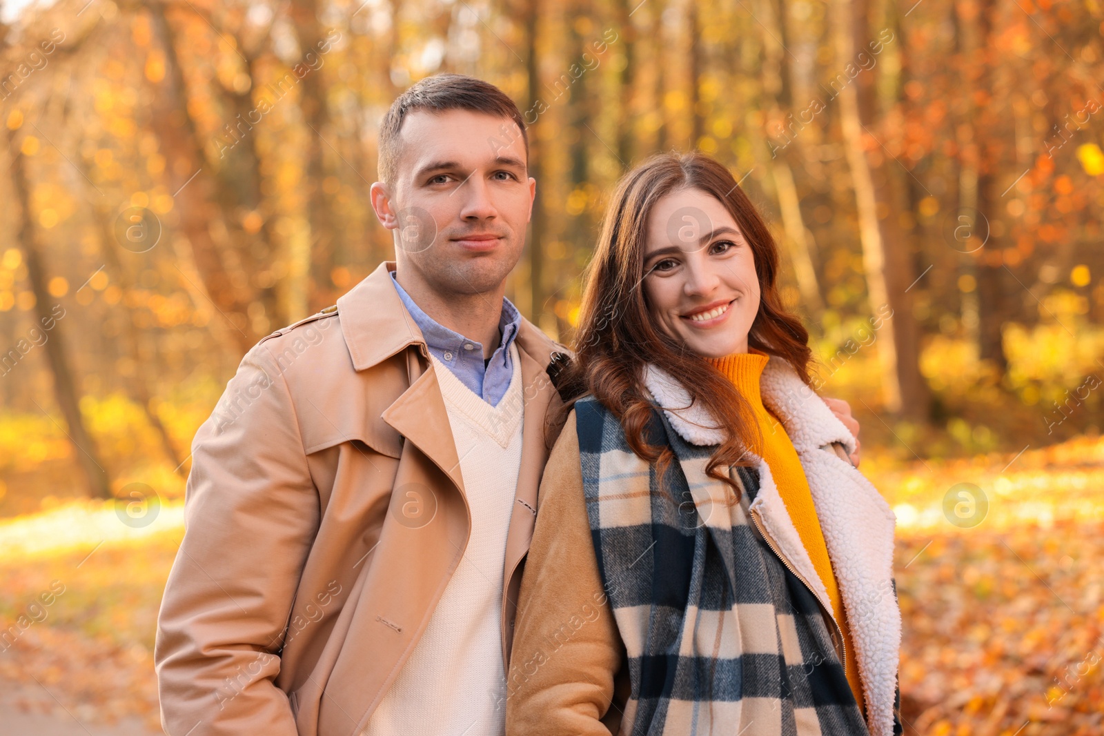 Photo of Happy couple spending time together in autumn park