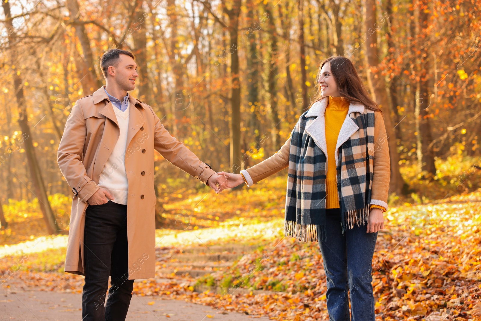 Photo of Happy couple spending time together in autumn park