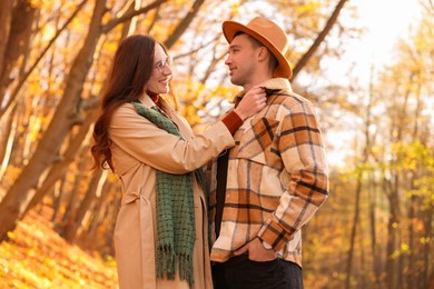 Photo of Happy couple spending time together in autumn park