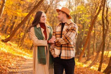 Photo of Happy couple spending time together in autumn park