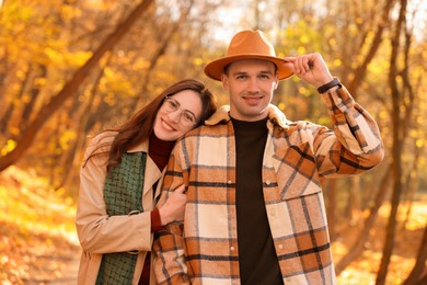 Photo of Happy couple spending time together in autumn park