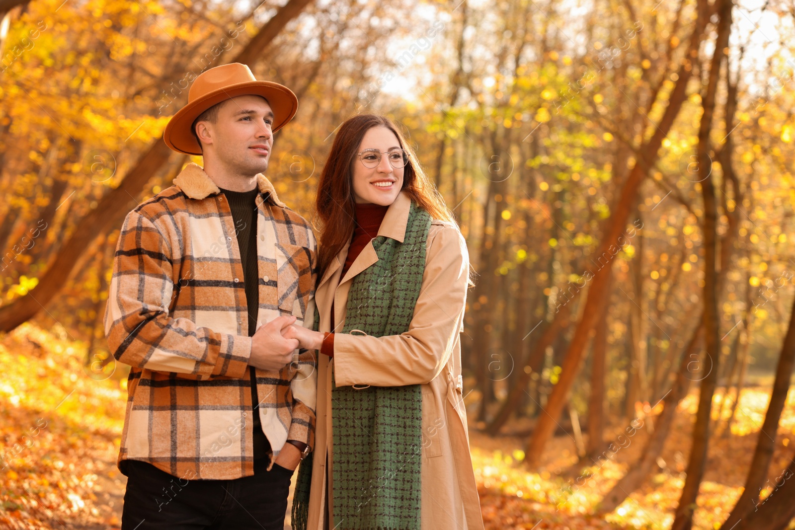 Photo of Happy couple spending time together in autumn park