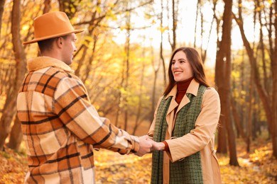 Photo of Happy couple spending time together in autumn park