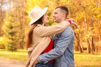 Photo of Happy couple spending time together in autumn park