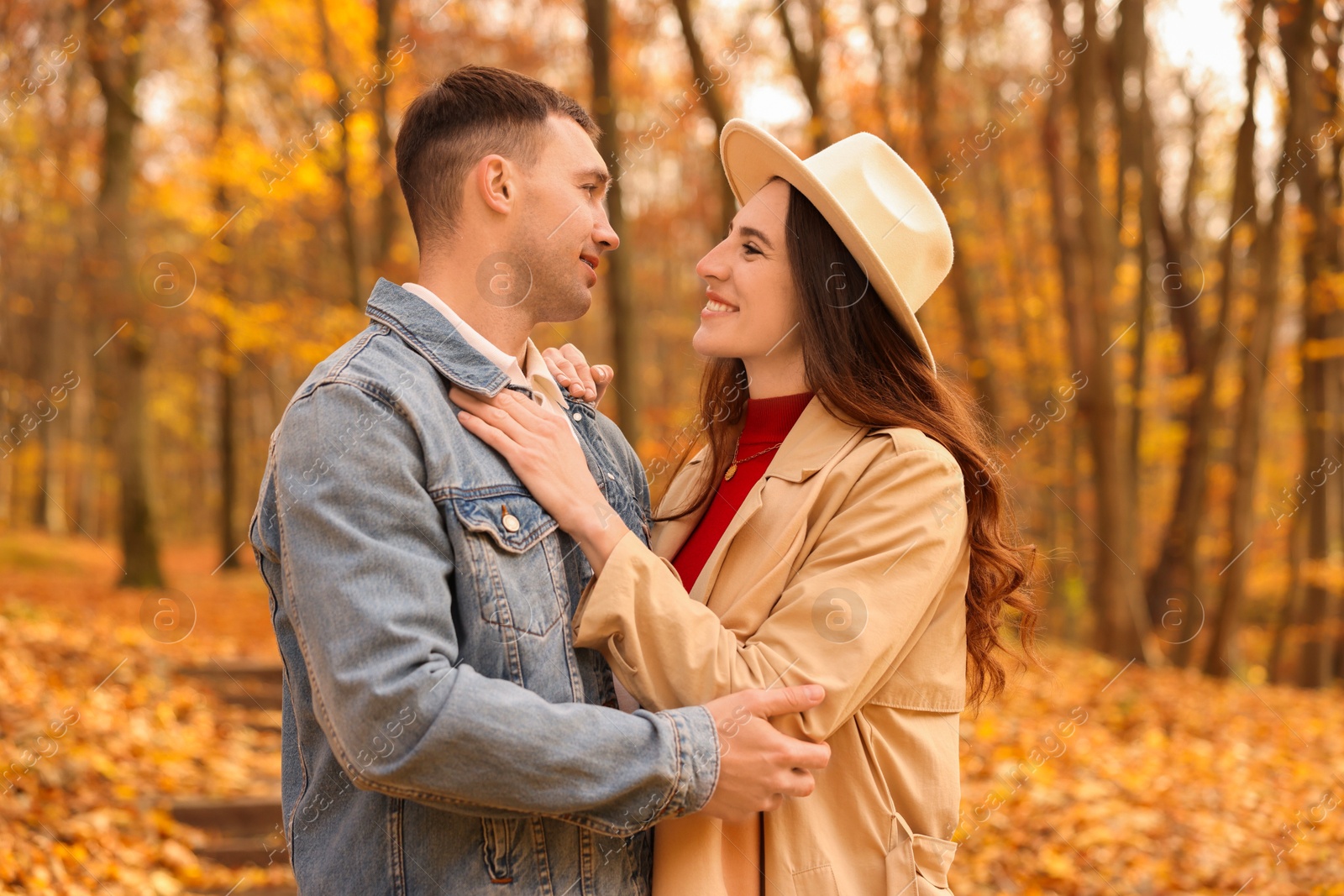 Photo of Happy couple spending time together in autumn park