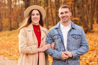 Photo of Happy couple spending time together in autumn park