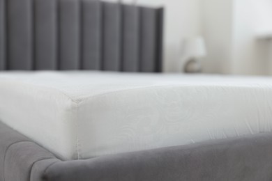 Photo of Bed with clean linens at home, closeup