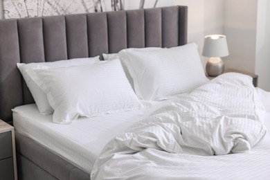 Photo of Bed with clean linens and pillows at home