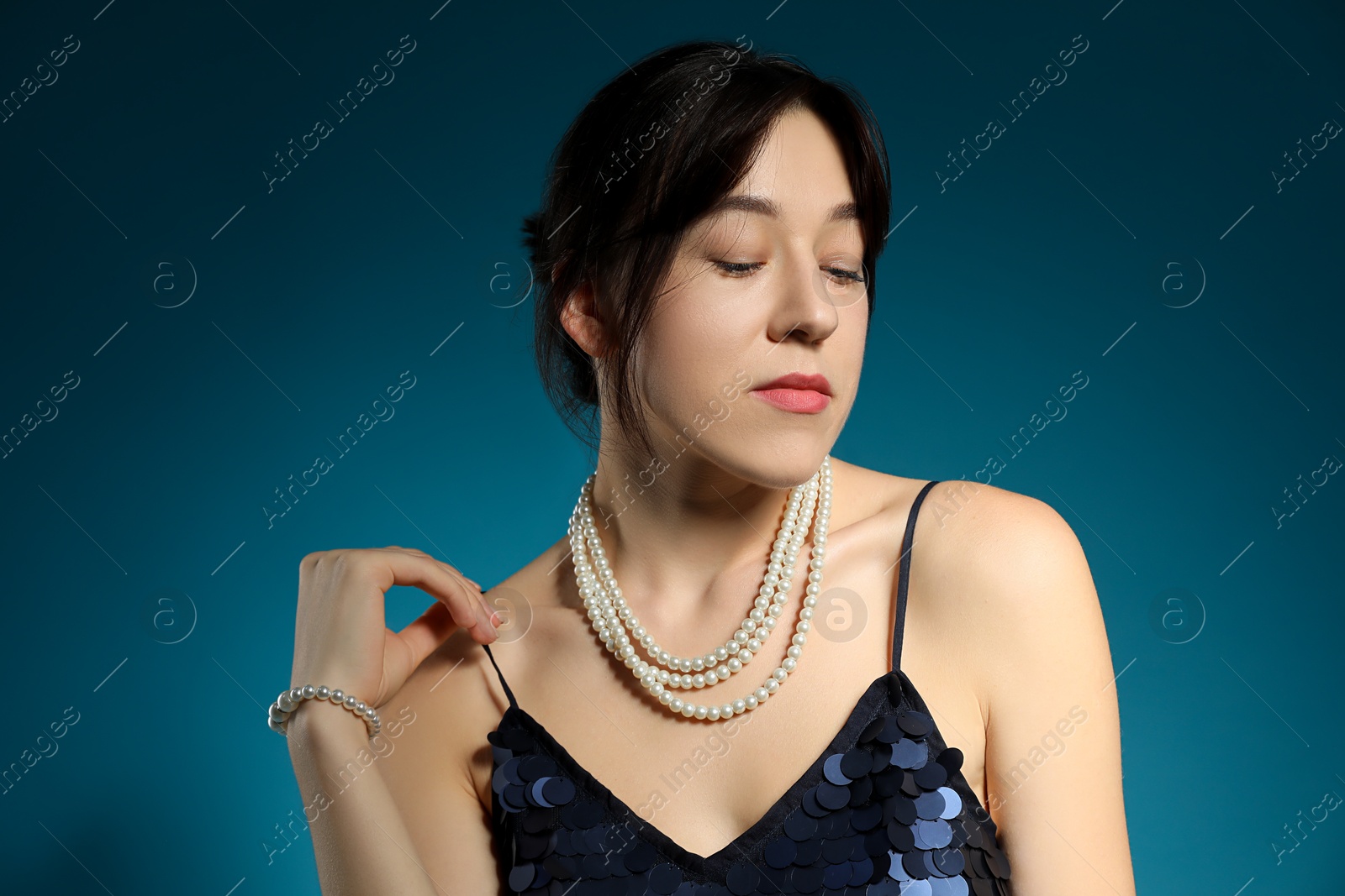 Photo of Beautiful young woman posing on blue background