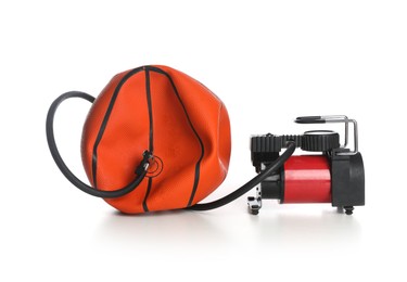 Photo of Deflated basketball ball and air compressor isolated on white