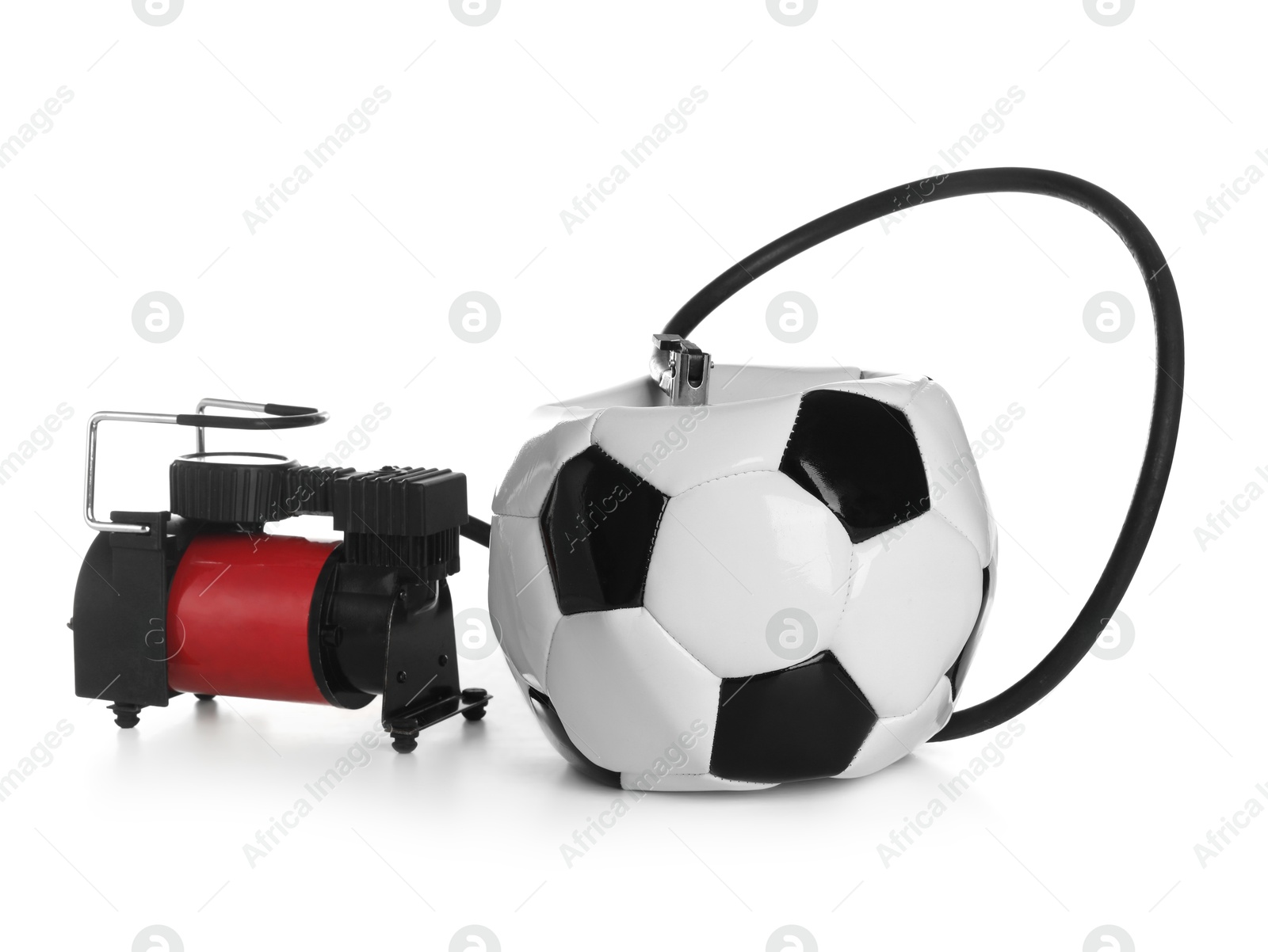 Photo of Deflated soccer ball and air compressor isolated on white