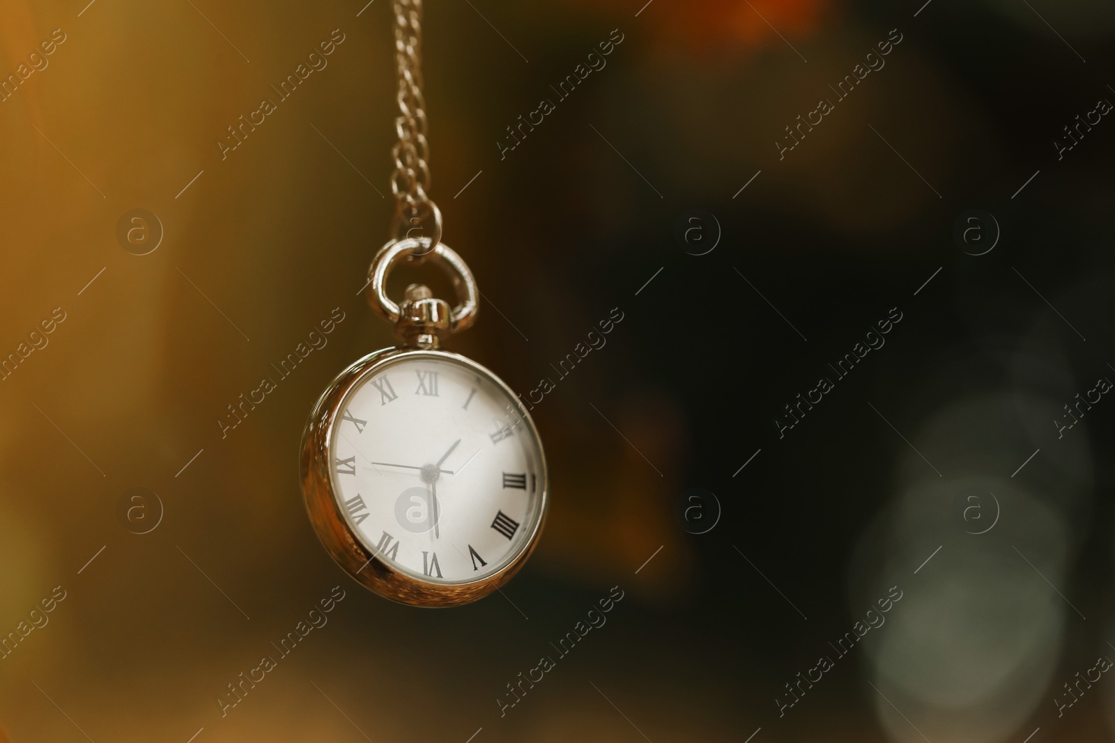 Photo of Autumn time. Chain watch on blurred background, closeup with space for text