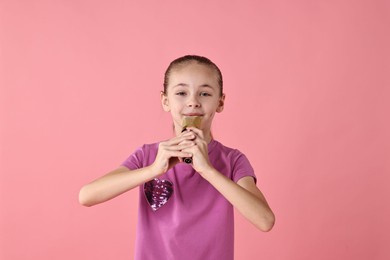 Photo of Little girl with microphone singing on pink background