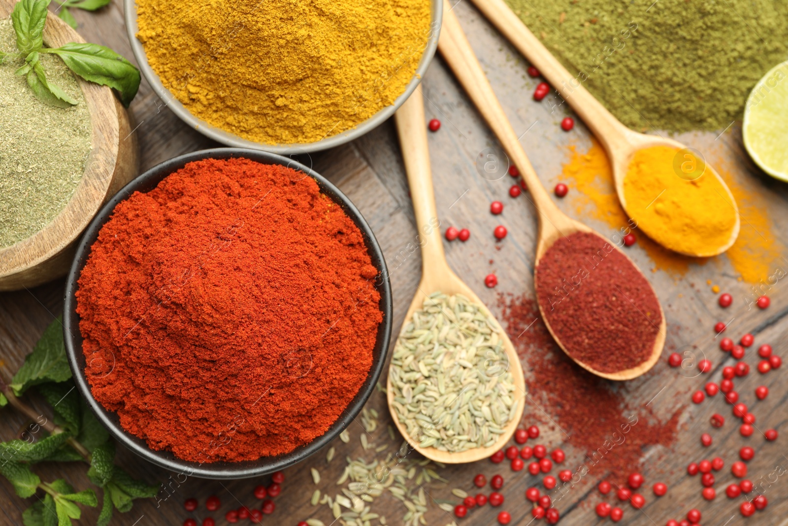 Photo of Different aromatic spices and herbs on wooden background, flat lay