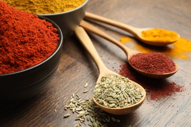 Photo of Different aromatic spices and herbs on wooden background, closeup