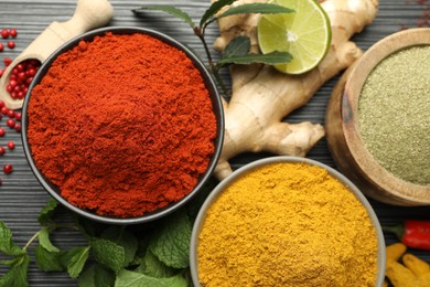 Photo of Different aromatic spices and herbs on black background, flat lay