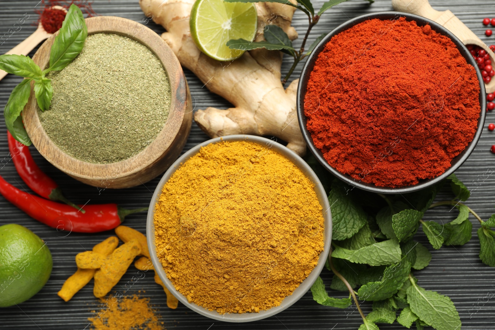 Photo of Different aromatic spices and herbs on black background, flat lay