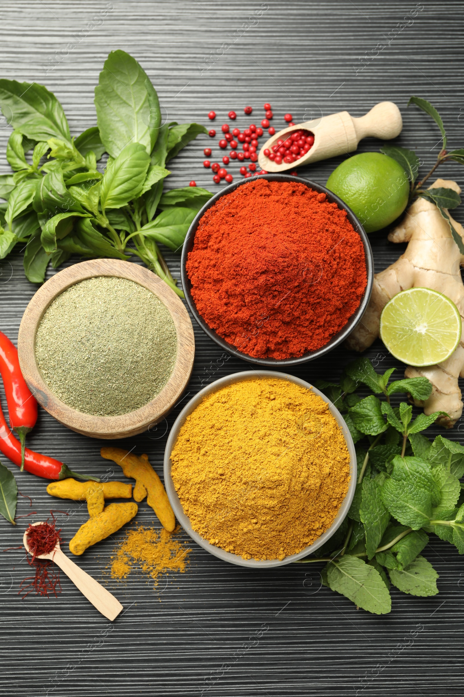 Photo of Different aromatic spices and herbs on black background, flat lay