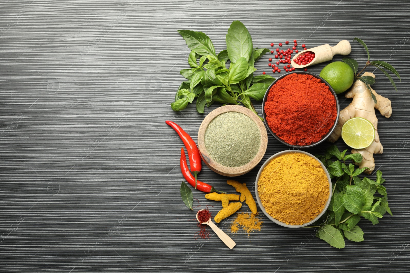 Photo of Different aromatic spices and herbs on black background, flat lay