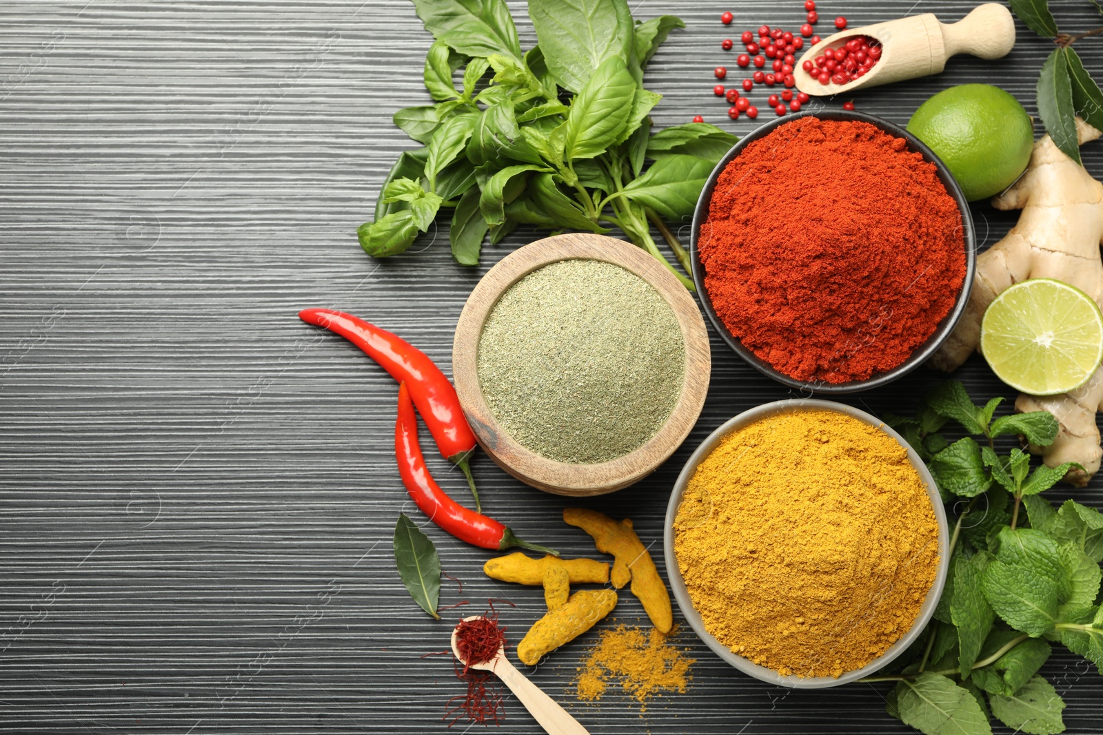 Photo of Different aromatic spices and herbs on black background, flat lay