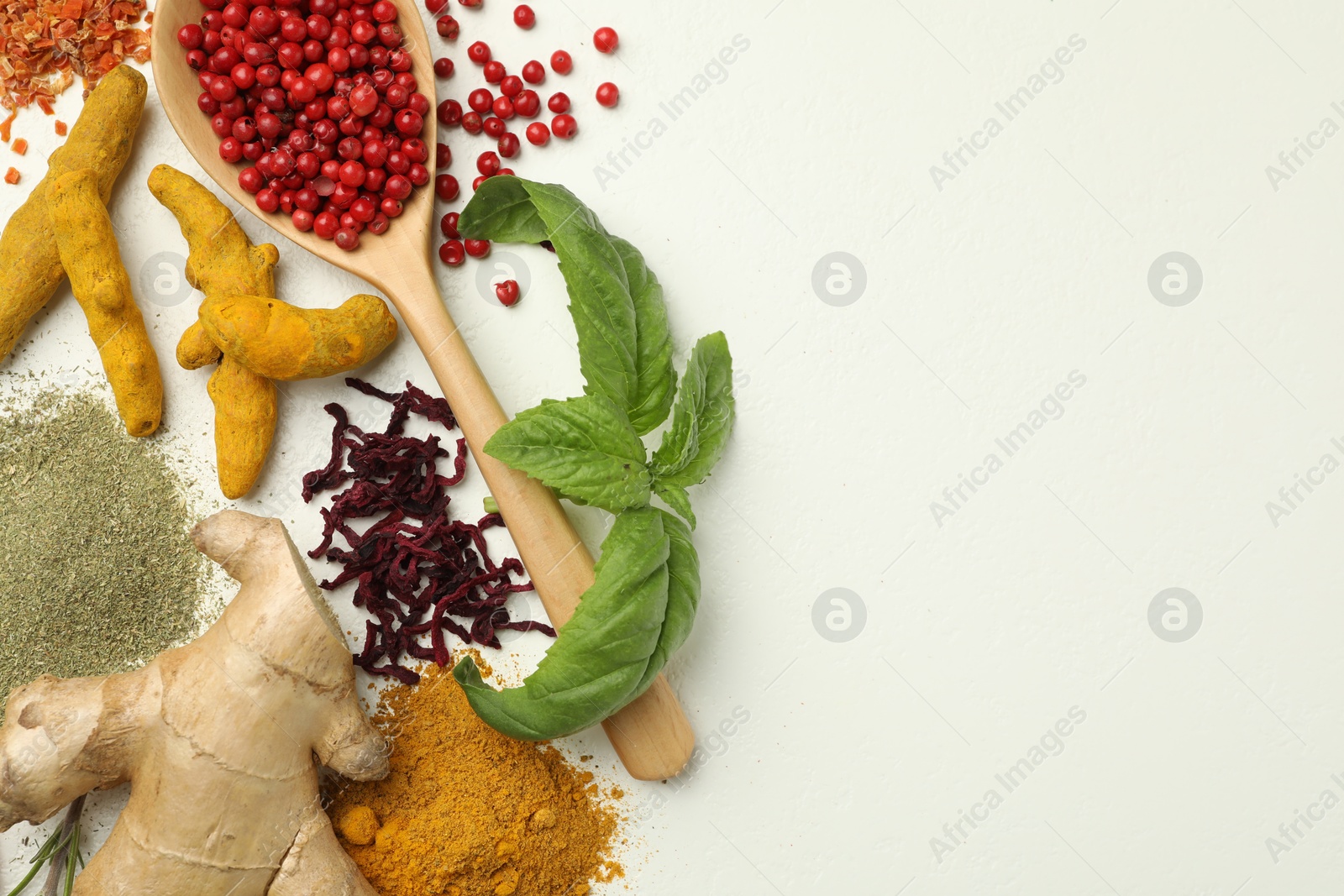 Photo of Different aromatic spices and herbs on white background, flat lay. Space for text