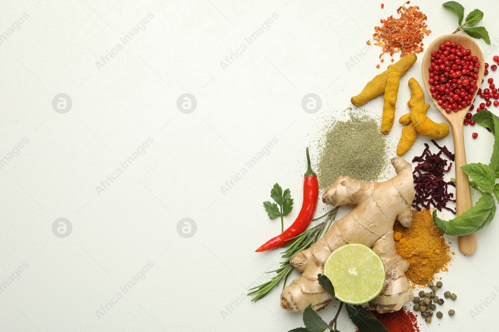 Photo of Different aromatic spices, lime and herbs on white background, flat lay. Space for text