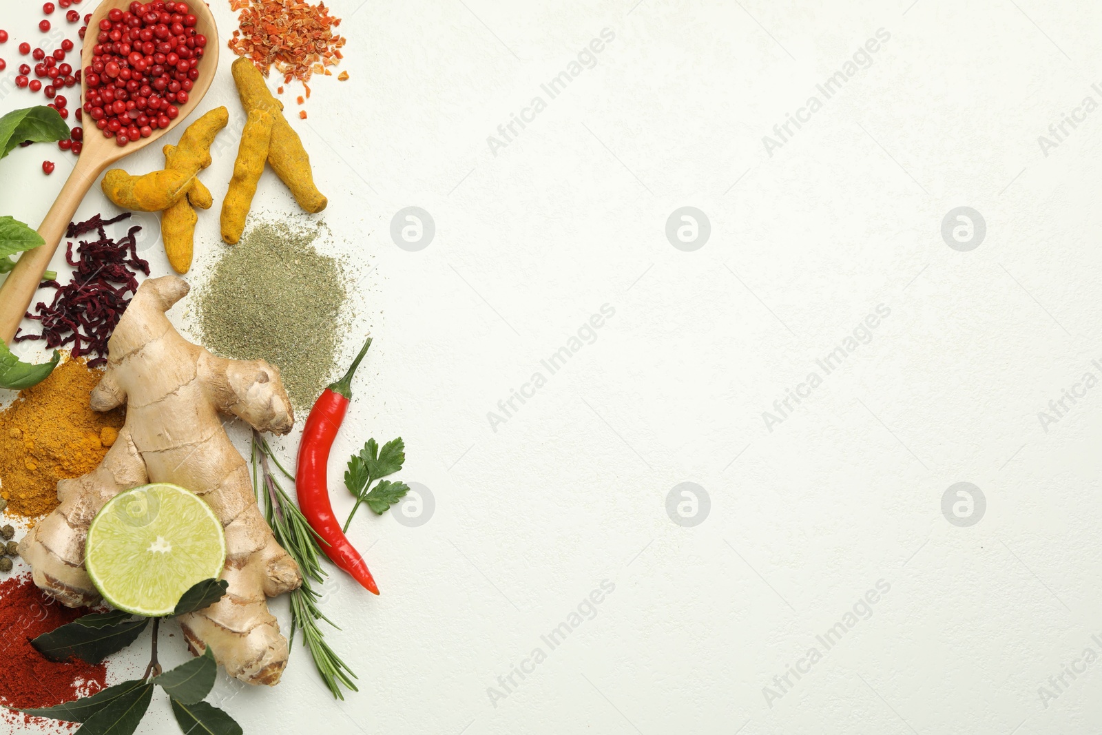 Photo of Different aromatic spices, lime and herbs on white background, flat lay. Space for text