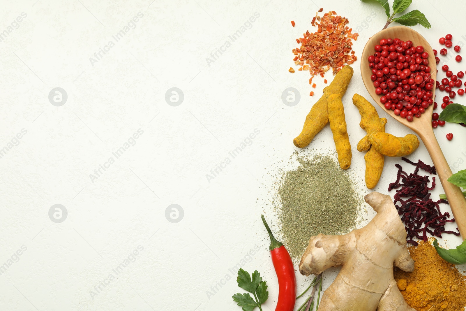 Photo of Different aromatic spices and herbs on white background, flat lay. Space for text