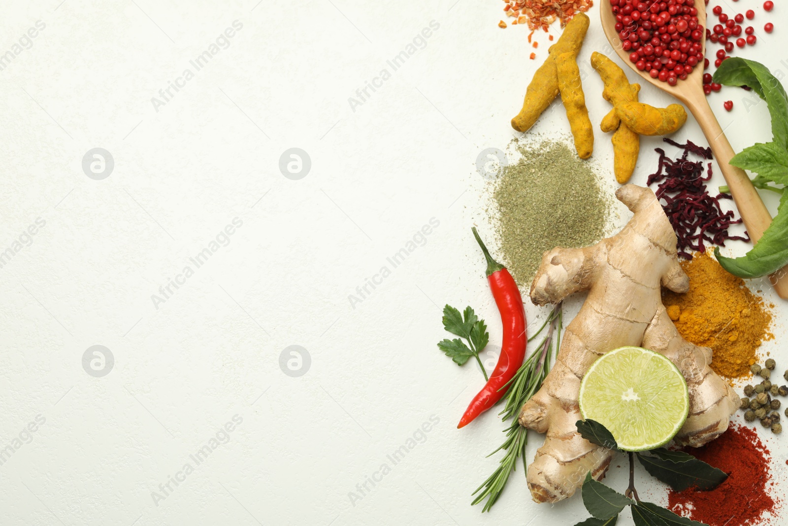 Photo of Different aromatic spices, lime and herbs on white background, flat lay. Space for text