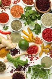 Photo of Different aromatic spices, lime and herbs on white background, flat lay