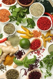 Photo of Different aromatic spices, lime and herbs on white background, flat lay