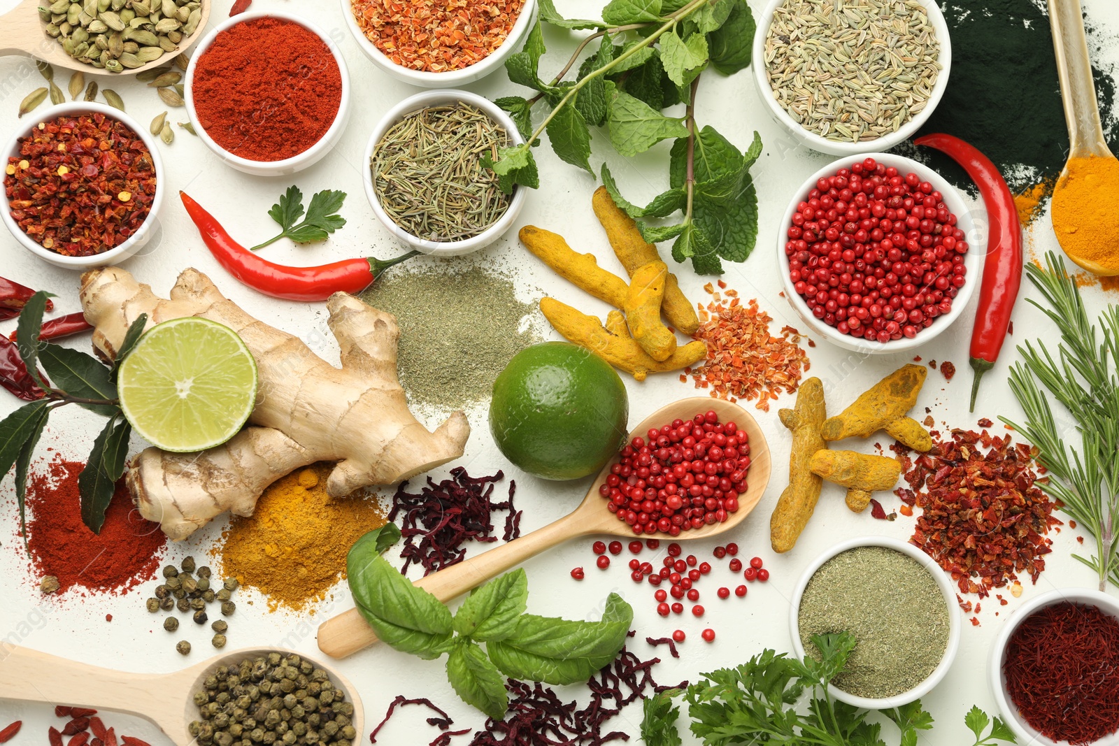 Photo of Different aromatic spices, lime and herbs on white background, flat lay