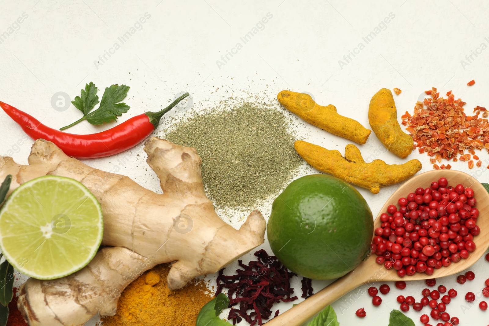 Photo of Different aromatic spices, lime and herbs on white background, flat lay