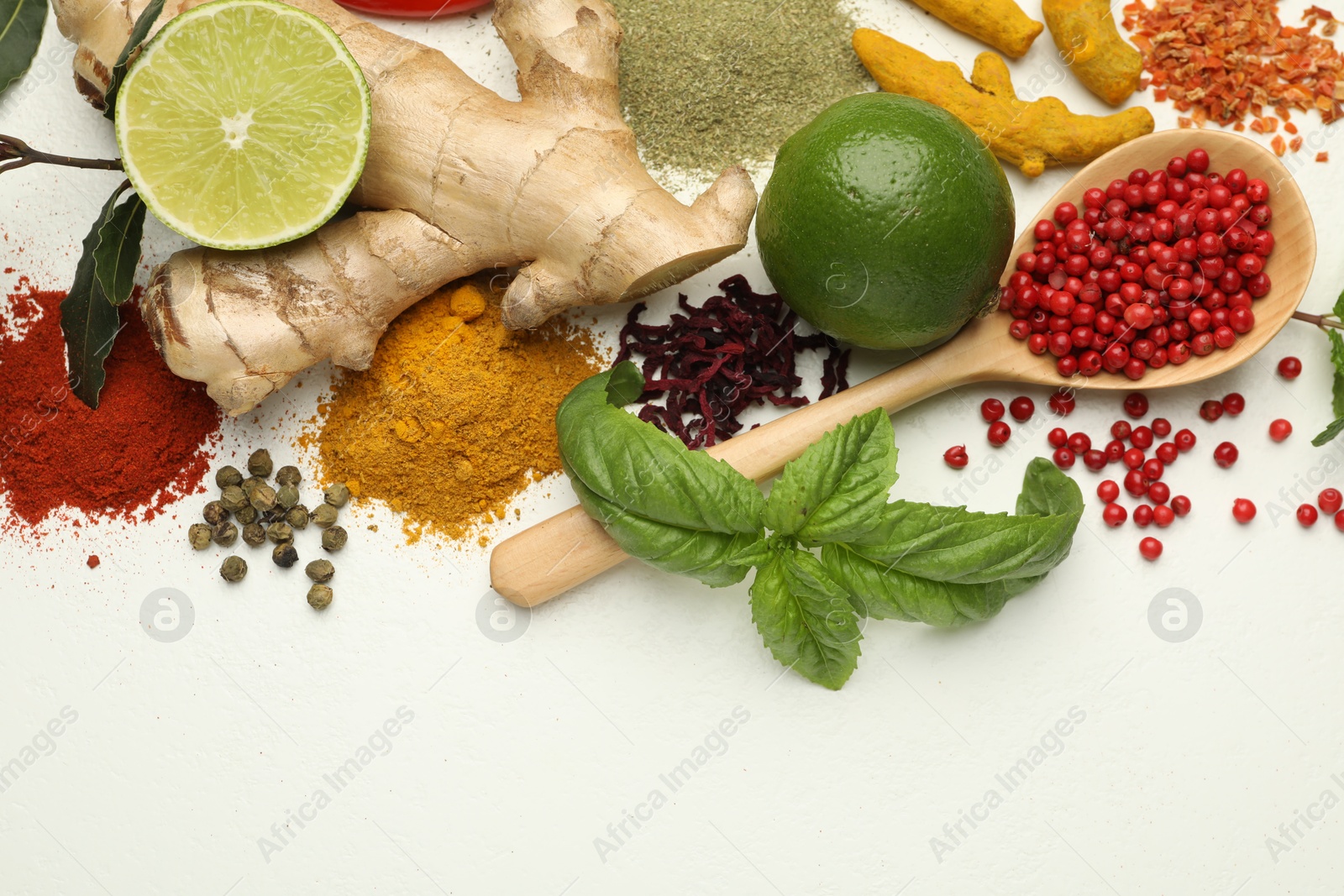 Photo of Different aromatic spices, lime and herbs on white background, flat lay