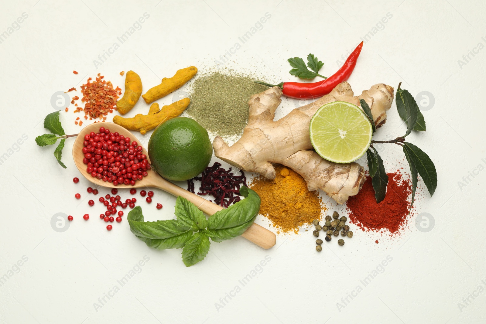 Photo of Different aromatic spices, lime and herbs on white background, flat lay