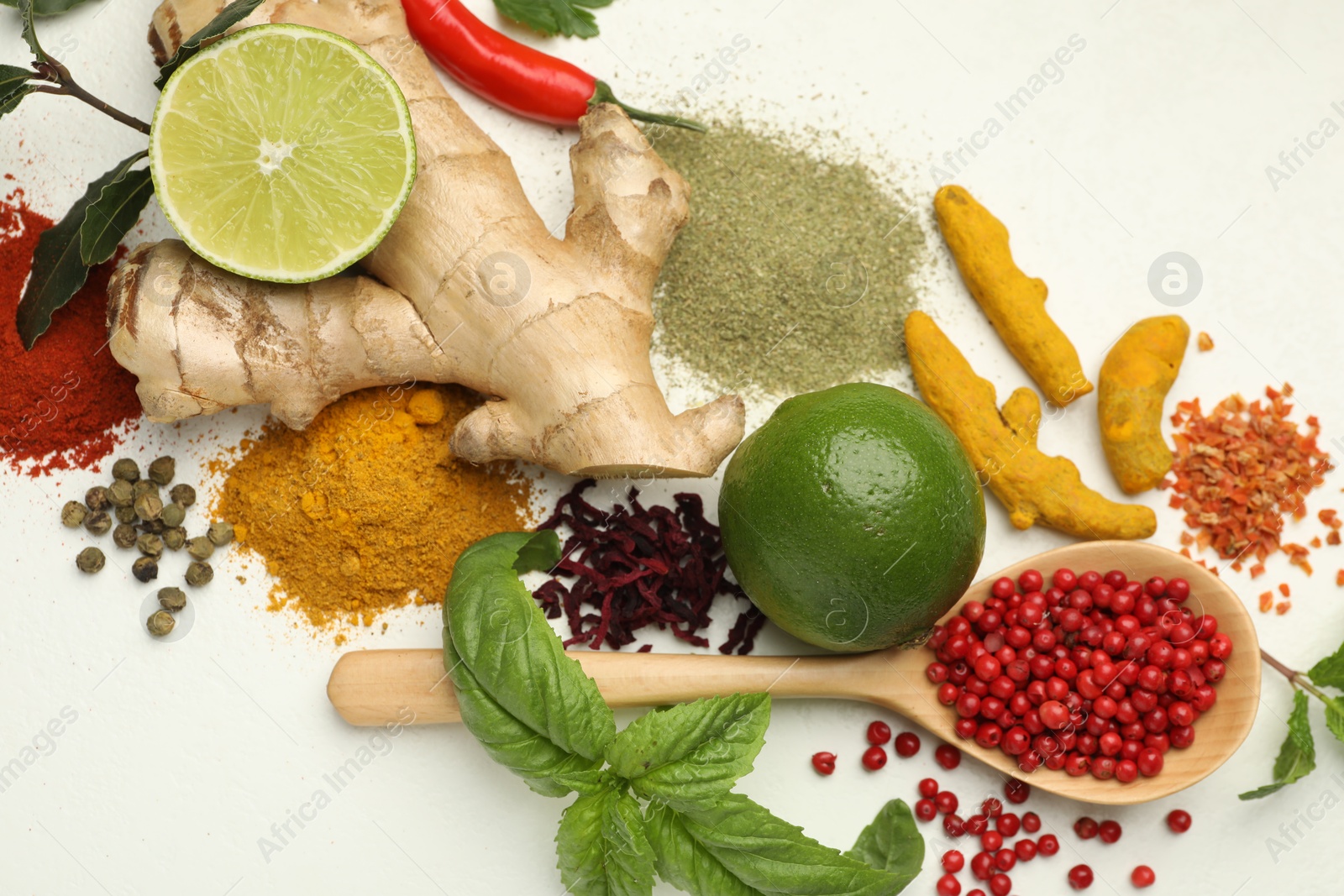 Photo of Different aromatic spices, lime and herbs on white background, flat lay